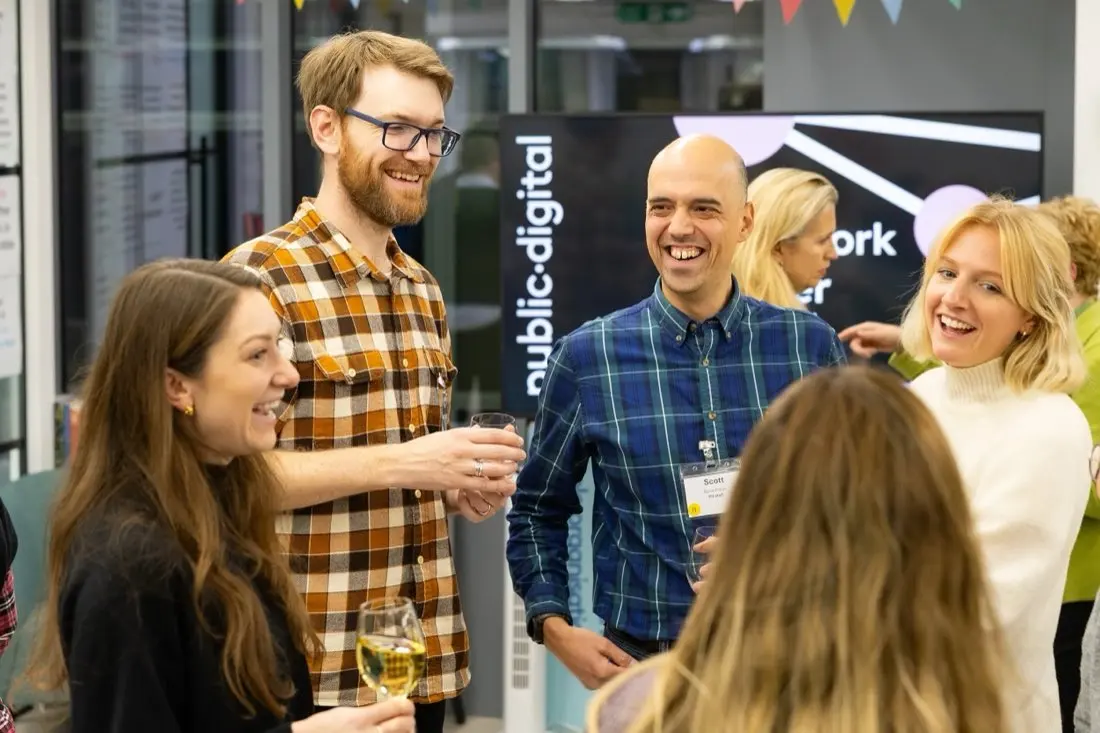 Scott talking with people at a networking event