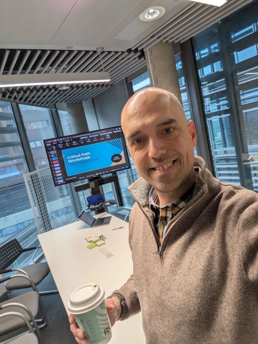 Scott at a workshop, coffee in hand